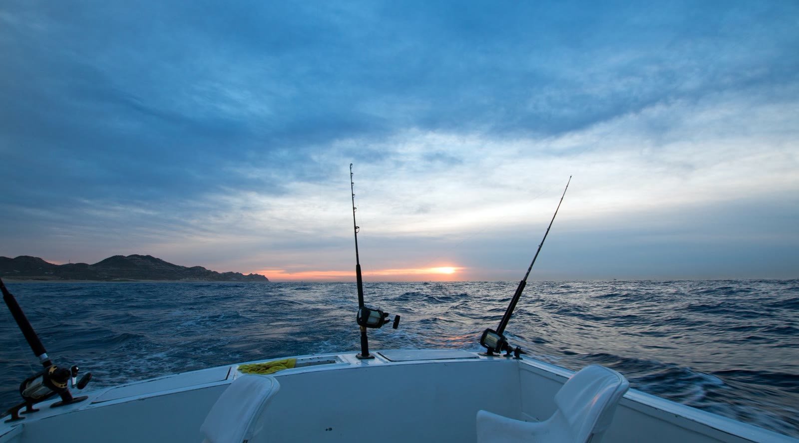 Sportfishing rods from the stern at sunrise on the Sea of Cortez