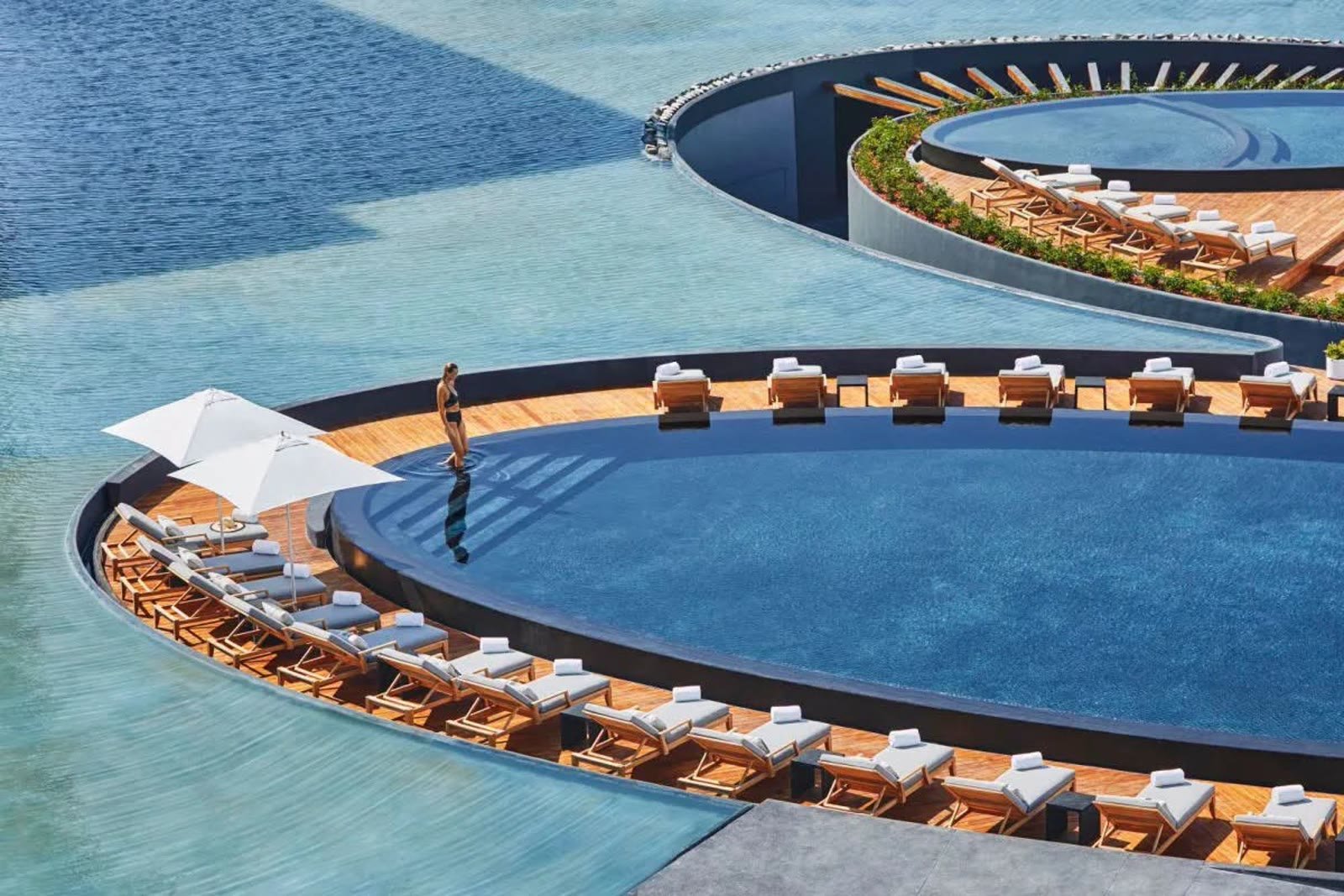 Luxury resort pool with turquoise water and lounge chairs