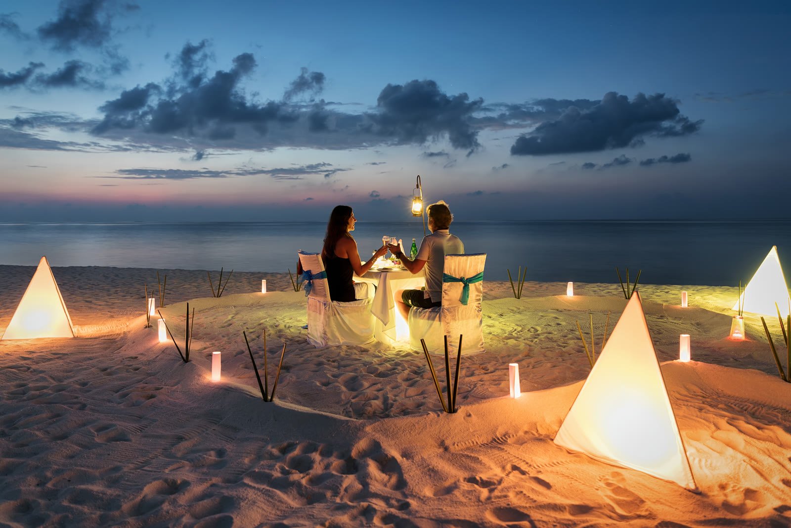 Private beach dinner on the sand at dusk in Cabo